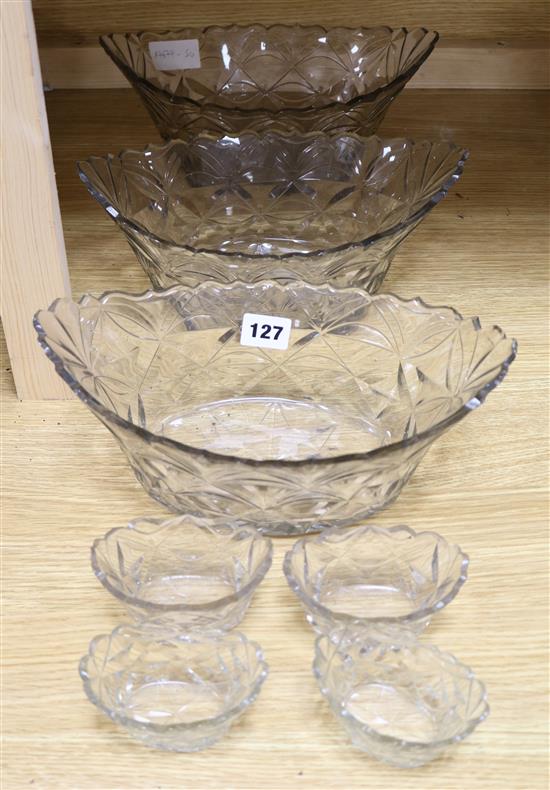 A part suite of late Georgian cut glass bowls and salts, bowls 11in.